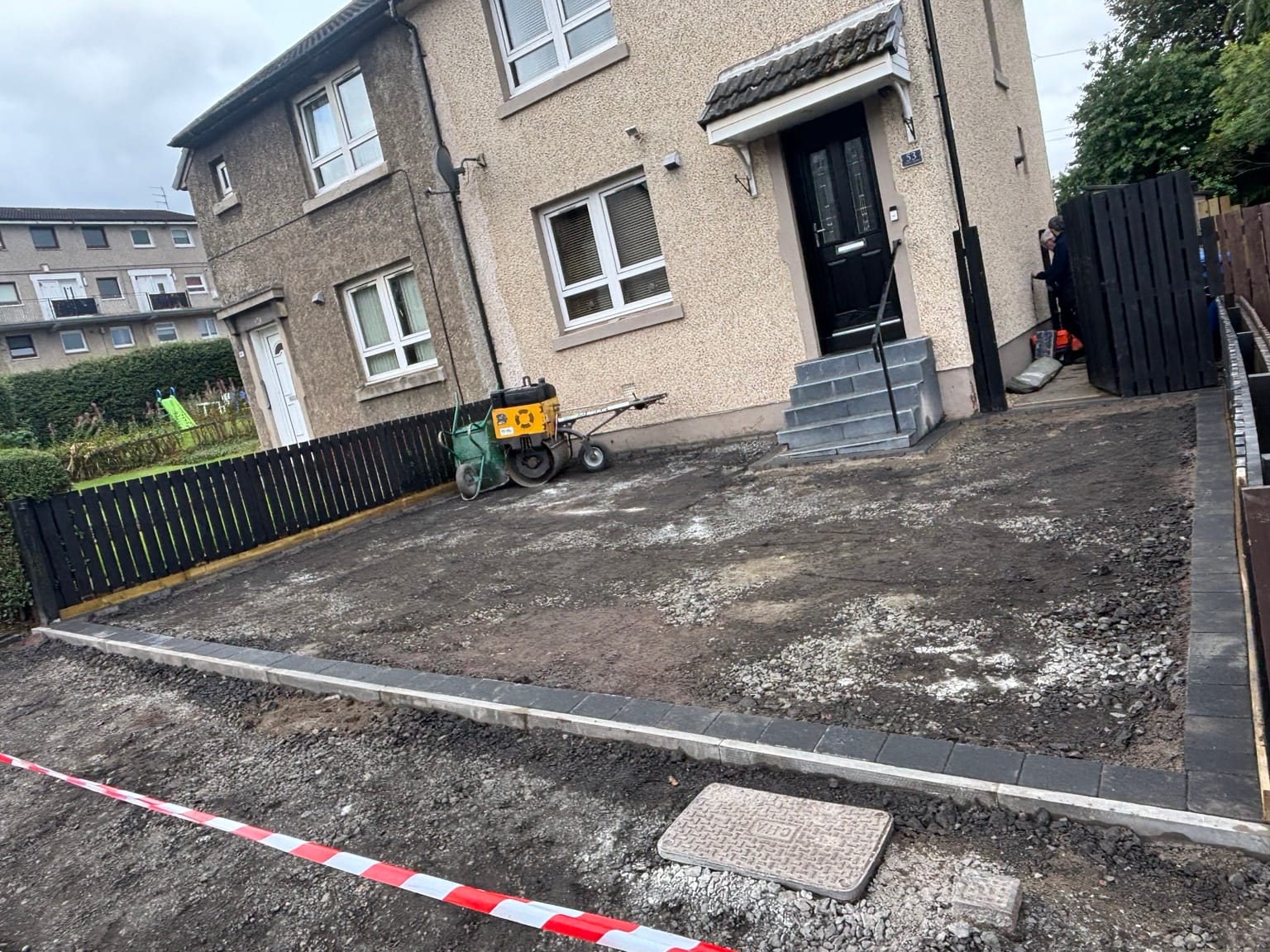 Contrasting block edging installed around the driveway